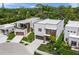 A stylish, two-story modern home that boasts landscaped grounds, wood accents and a convenient driveway at 4726 Rivetta Ct, Sarasota, FL 34231