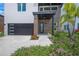 A modern exterior view with a landscaped yard showcasing the front entryway, with its clean lines and stylish design at 4726 Rivetta Ct, Sarasota, FL 34231