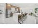 Bright kitchen with large island, bar seating, and stainless-steel appliances at 4726 Rivetta Ct, Sarasota, FL 34231
