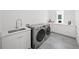 Modern laundry room featuring stainless steel washer and dryer, and ample counter space at 4726 Rivetta Ct, Sarasota, FL 34231
