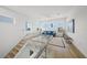 Bright living room with modern finishes, a glass railing staircase, and plentiful natural light at 4726 Rivetta Ct, Sarasota, FL 34231