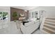Living room with wood accent wall and modern decor, steps lead to upper level at 4726 Rivetta Ct, Sarasota, FL 34231
