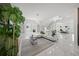 Bright living room featuring marble floors, modern decor, and glass-railed staircase at 4726 Rivetta Ct, Sarasota, FL 34231