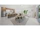 Open concept living space featuring dining area, kitchen with bar seating, and white marble tile floors at 4726 Rivetta Ct, Sarasota, FL 34231