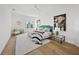 Spacious main bedroom boasts hardwood floors, a plush rug, and lots of natural light at 4726 Rivetta Ct, Sarasota, FL 34231