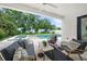Inviting covered pool patio with stylish seating and a view of the sparkling pool and lush backyard at 4726 Rivetta Ct, Sarasota, FL 34231