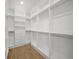 Spacious walk-in closet with custom shelves, drawers, and rods perfect for organized storage at 4726 Rivetta Ct, Sarasota, FL 34231