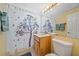 Bathroom featuring a shower with a decorative curtain, a toilet, and a mirror at 475 Benjamin Franklin Dr # 211, Sarasota, FL 34236