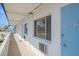 Exterior view of a condo with white siding, light blue door, and beach views at 475 Benjamin Franklin Dr # 211, Sarasota, FL 34236