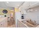 Kitchen featuring white cabinets, stainless sink, and bright, neutral décor at 475 Benjamin Franklin Dr # 211, Sarasota, FL 34236