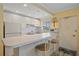 Bright kitchen with white cabinets, breakfast bar, and modern appliances at 475 Benjamin Franklin Dr # 211, Sarasota, FL 34236