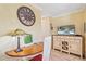 Cozy living area featuring a decorative lamp, television and cabinet with wine rack, perfect for relaxing at 475 Benjamin Franklin Dr # 211, Sarasota, FL 34236