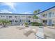 Patio featuring lounge chairs and patio sets with views of tropical landscaping and the building's balconies at 475 Benjamin Franklin Dr # 211, Sarasota, FL 34236