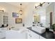 This bathroom boasts a large soaking tub, double sink vanities and modern fixtures at 5091 Creekside Trl, Sarasota, FL 34243
