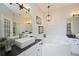 This bathroom boasts a large soaking tub, double sink vanities and modern fixtures at 5091 Creekside Trl, Sarasota, FL 34243