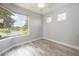 Bedroom with large window overlooking a peaceful lake at 5091 Creekside Trl, Sarasota, FL 34243