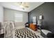 This bedroom features a ceiling fan, area rug, and a beautiful decor setup at 5091 Creekside Trl, Sarasota, FL 34243