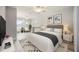 Bright bedroom featuring natural light, neutral decor and serene views of the lake at 5091 Creekside Trl, Sarasota, FL 34243