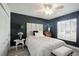 Well-lit bedroom with an area rug, and a large window at 5091 Creekside Trl, Sarasota, FL 34243