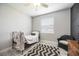 Cozy bedroom with a decorative rug, accent chair, and plenty of natural light at 5091 Creekside Trl, Sarasota, FL 34243