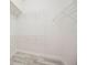 Walk in closet with white wire shelving and light gray floors at 5091 Creekside Trl, Sarasota, FL 34243