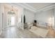 Inviting foyer with elegant lighting, neutral paint, tile floors, and a view of the front door at 5091 Creekside Trl, Sarasota, FL 34243