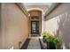 Inviting entryway with a glass front door, elegant sidelights, and decorative potted plants at 5091 Creekside Trl, Sarasota, FL 34243