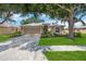 Charming single-story home featuring a manicured lawn, mature tree, and a welcoming two-car garage at 5091 Creekside Trl, Sarasota, FL 34243
