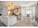 Stylish kitchen with a central island, pendant lighting, and a cozy breakfast nook overlooking the backyard at 5091 Creekside Trl, Sarasota, FL 34243