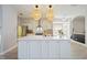 Modern kitchen with a spacious island, unique backsplash, and a seamless flow to the dining area at 5091 Creekside Trl, Sarasota, FL 34243