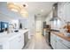 Well-appointed kitchen featuring a large island, stylish pendant lights, and a view of the adjacent living area at 5091 Creekside Trl, Sarasota, FL 34243