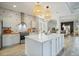 Gourmet kitchen featuring a large island, pendant lighting, and stainless steel appliances for the culinary enthusiast at 5091 Creekside Trl, Sarasota, FL 34243