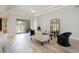 Bright living room featuring modern furnishings, tile flooring, and sliding door access to outdoor spaces at 5091 Creekside Trl, Sarasota, FL 34243
