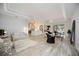 Spacious open-concept living room with tray ceilings, tile flooring, and neutral decor at 5091 Creekside Trl, Sarasota, FL 34243