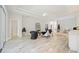 Elegant living room featuring tray ceilings, wood-look tile flooring, and stylish decor, creating a welcoming ambiance at 5091 Creekside Trl, Sarasota, FL 34243