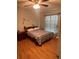 Bedroom featuring hardwood floors, a bed, and natural lighting with a decorative window at 5094 Bunyan St, Sarasota, FL 34232