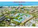 Stunning aerial view of community's proximity to Siesta Key Beach, tennis courts, and serene ponds at 5669 Midnight Pass Rd # 308, Sarasota, FL 34242