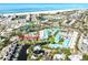 Aerial view of the condo complex, beach, boat docks, tennis courts, and lush landscaping at 5669 Midnight Pass Rd # 308, Sarasota, FL 34242