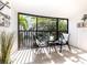 Relaxing screened balcony with comfortable seating and lush tropical views at 5669 Midnight Pass Rd # 308, Sarasota, FL 34242