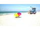 Beautiful Siesta Key Beach featuring lifeguard tower, people enjoying the sun, and clear ocean at 5669 Midnight Pass Rd # 308, Sarasota, FL 34242