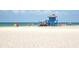 Scenic view of Siesta Key Beach with a lifeguard tower, clear water, and soft white sand at 5669 Midnight Pass Rd # 308, Sarasota, FL 34242