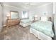 Bright bedroom featuring two twin beds, coastal decor, and large window at 5669 Midnight Pass Rd # 308, Sarasota, FL 34242