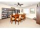 Community room with ample book shelves, large table, and a ceiling fan at 5669 Midnight Pass Rd # 308, Sarasota, FL 34242