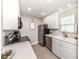 Compact, updated kitchen featuring stainless steel appliances and bright white cabinetry at 5669 Midnight Pass Rd # 308, Sarasota, FL 34242