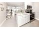Bright, modern kitchen with stainless steel appliances and breakfast bar open to the living area at 5669 Midnight Pass Rd # 308, Sarasota, FL 34242
