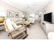 Inviting living room with neutral tones, tile flooring, and comfortable seating arrangement at 5669 Midnight Pass Rd # 308, Sarasota, FL 34242
