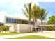 Exterior of Siesta Beach facilities showcasing modern architecture, palm trees, and green space at 5669 Midnight Pass Rd # 308, Sarasota, FL 34242