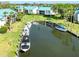 A picturesque waterfront community with docks and boats surrounded by lush greenery and palm trees at 5669 Midnight Pass Rd # 308, Sarasota, FL 34242