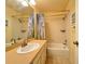 Bathroom featuring a single sink vanity, tiled backsplash, and a shower-tub combo at 5804 Garden Lakes Fern, Bradenton, FL 34203