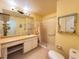 Well-lit bathroom featuring a single sink vanity and glass-enclosed shower with a grab bar at 5804 Garden Lakes Fern, Bradenton, FL 34203